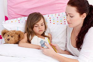 Mom giving cough meds to child