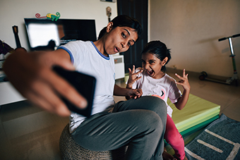 Mom and young daughter taking a selfie