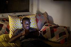 Teen in bed on iPad