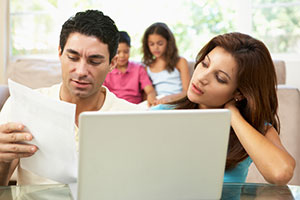 Parents on computer with paperwork