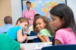 Girl being bullied in class by other girls
